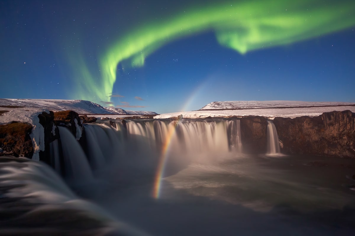 Rainbow and Northern Lights Over Godafoss Waterfalls in Iceland